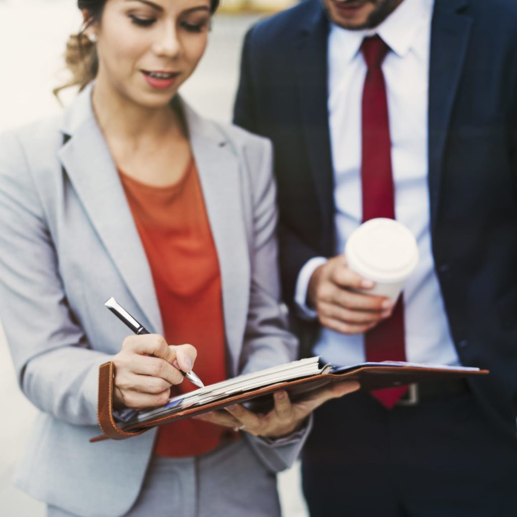 A coaching conversation between two business colleagues over coffee