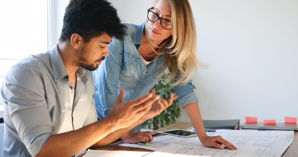 Colleagues reviewing plans together at a work table